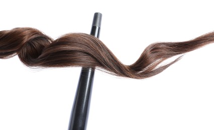 Photo of Curling iron with brown hair lock isolated on white
