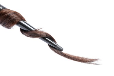 Photo of Curling iron with brown hair lock isolated on white