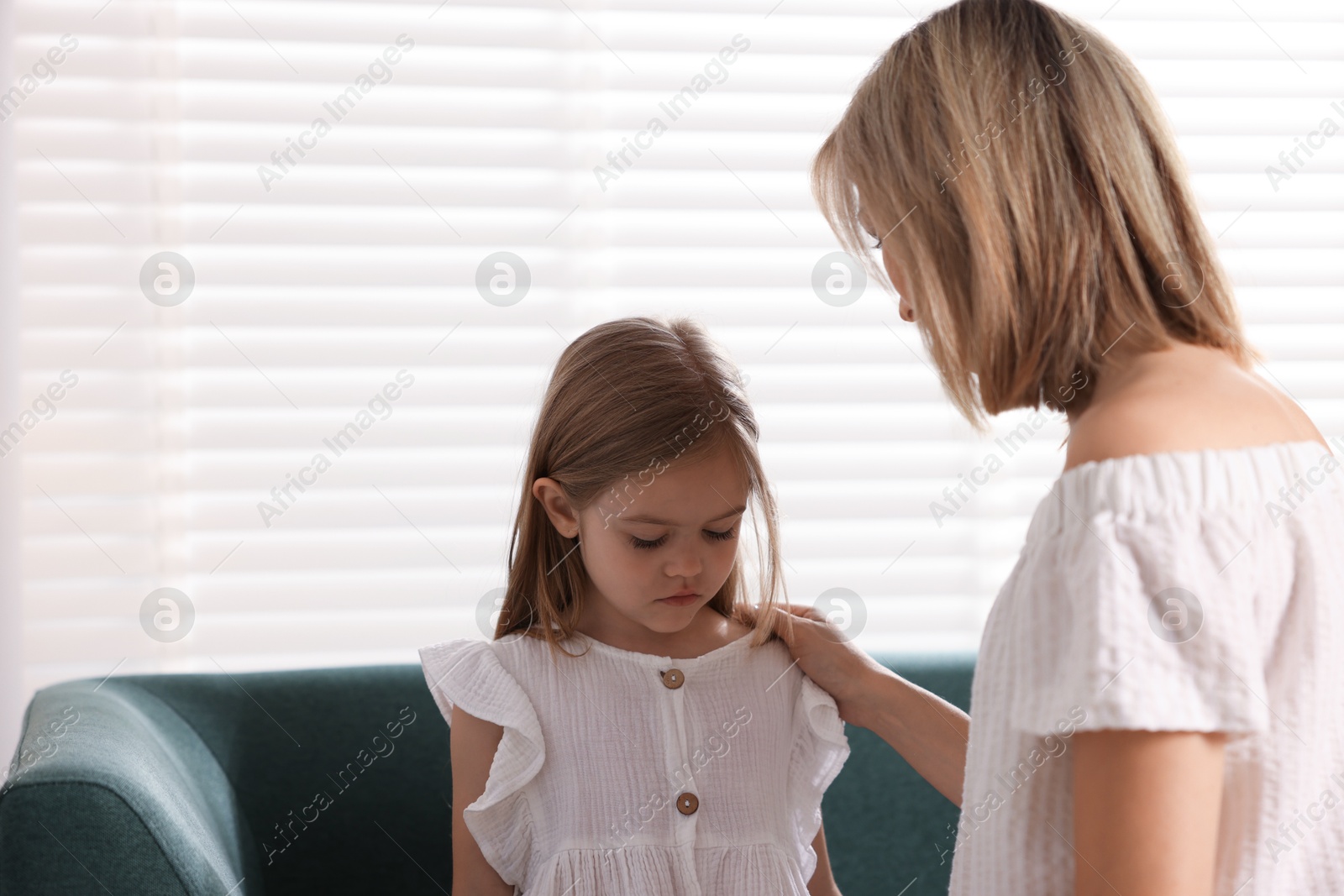 Photo of Mother apologizing to her sad daughter at home