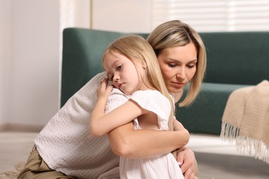 Photo of Mother and her daughter hugging after apology at home