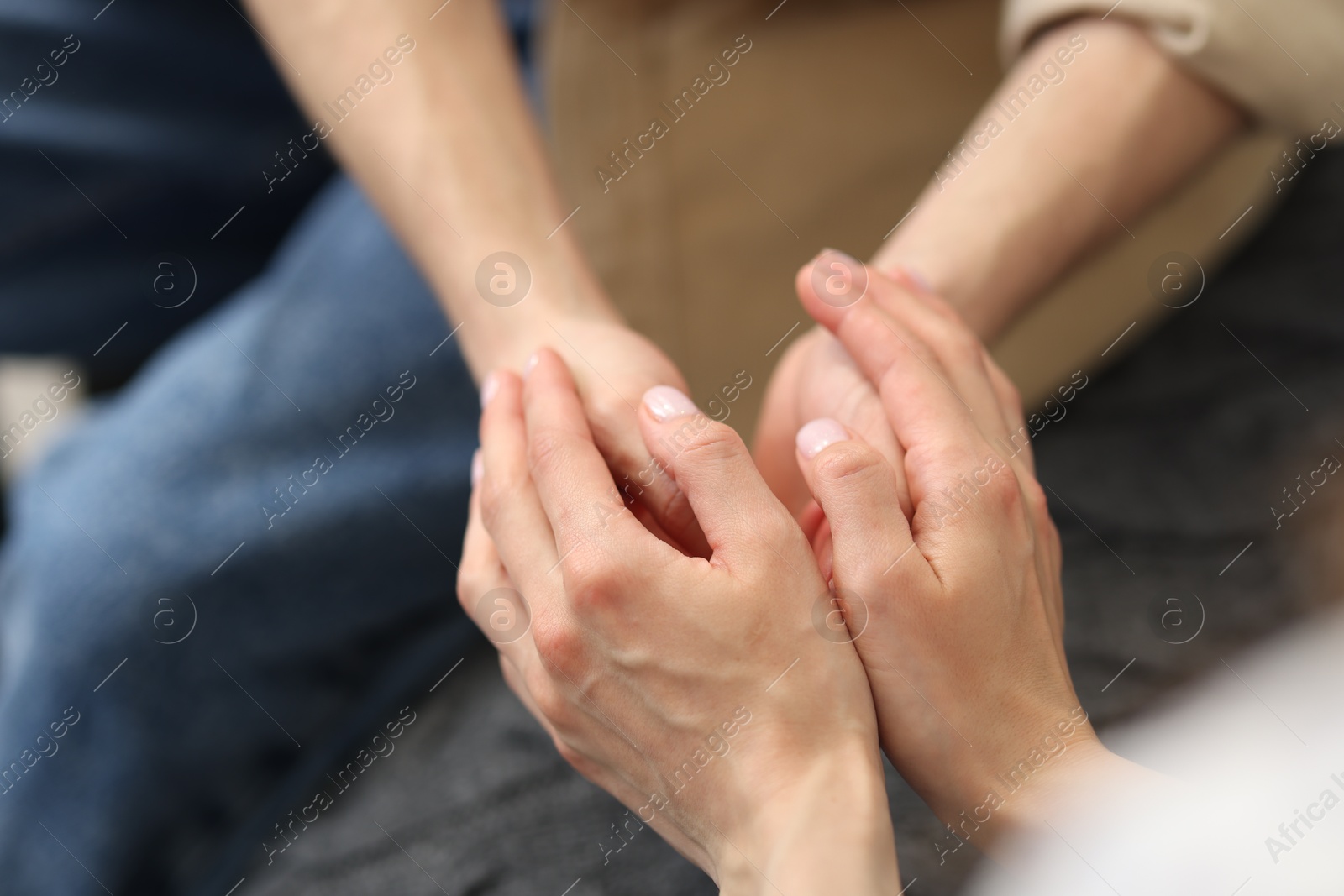 Couple holding hands after apology indoors, closeup Photo of Couple holding hands after apology indoors, closeup