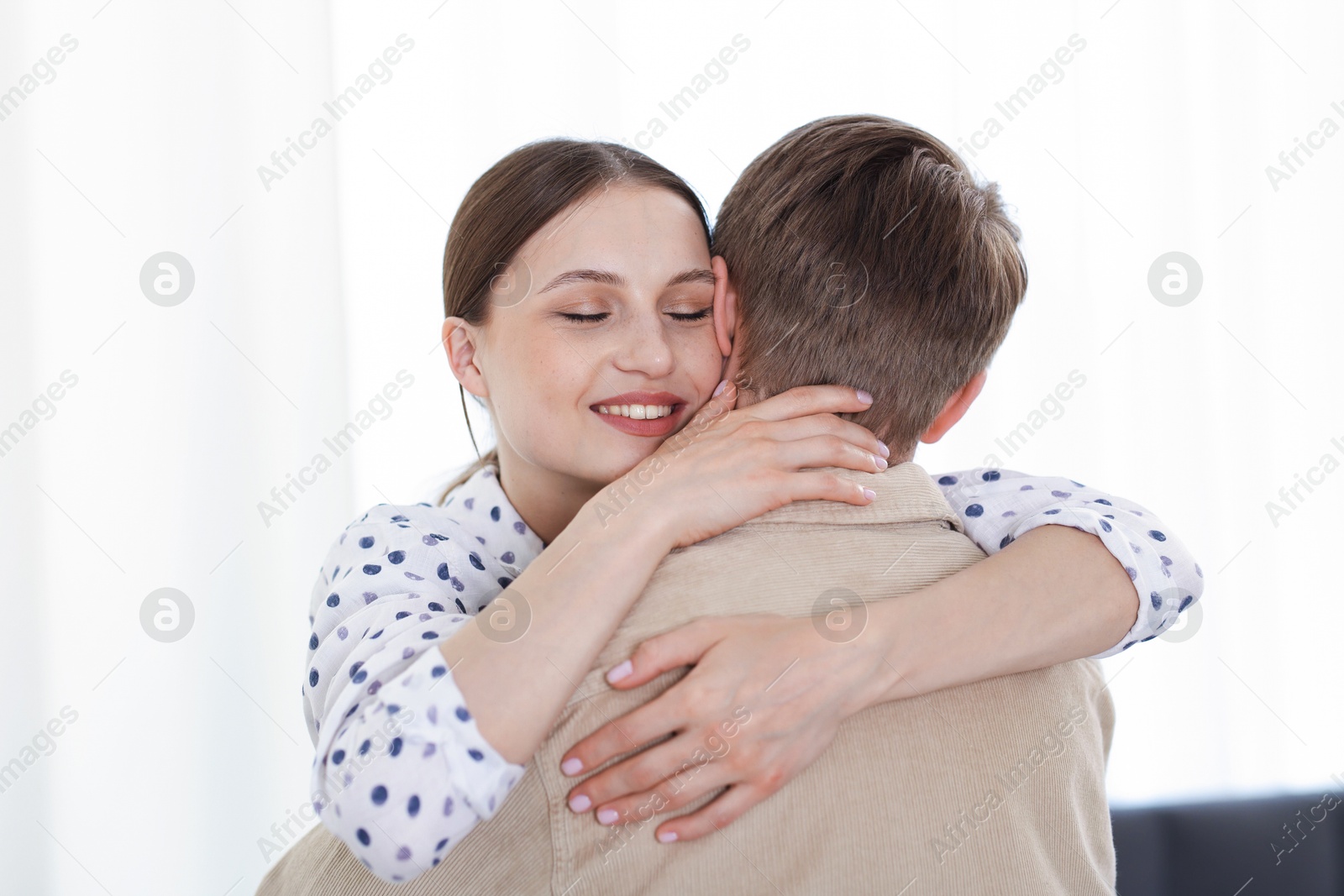Photo of Happy couple hugging after apology at home