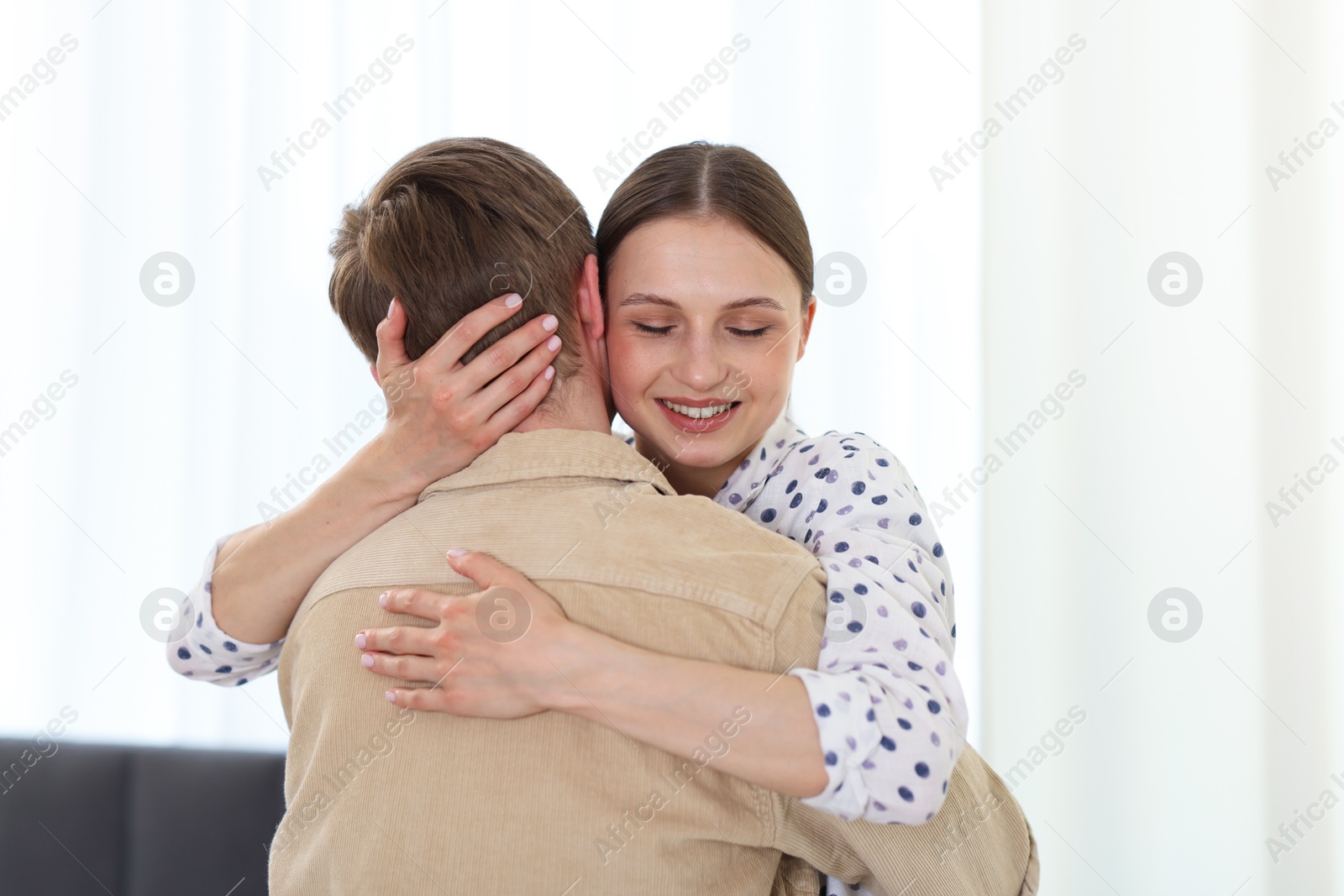 Photo of Happy couple hugging after apology at home