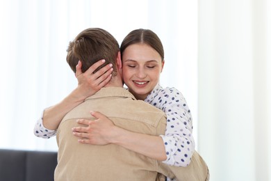 Photo of Happy couple hugging after apology at home