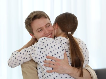 Photo of Happy couple hugging after apology at home