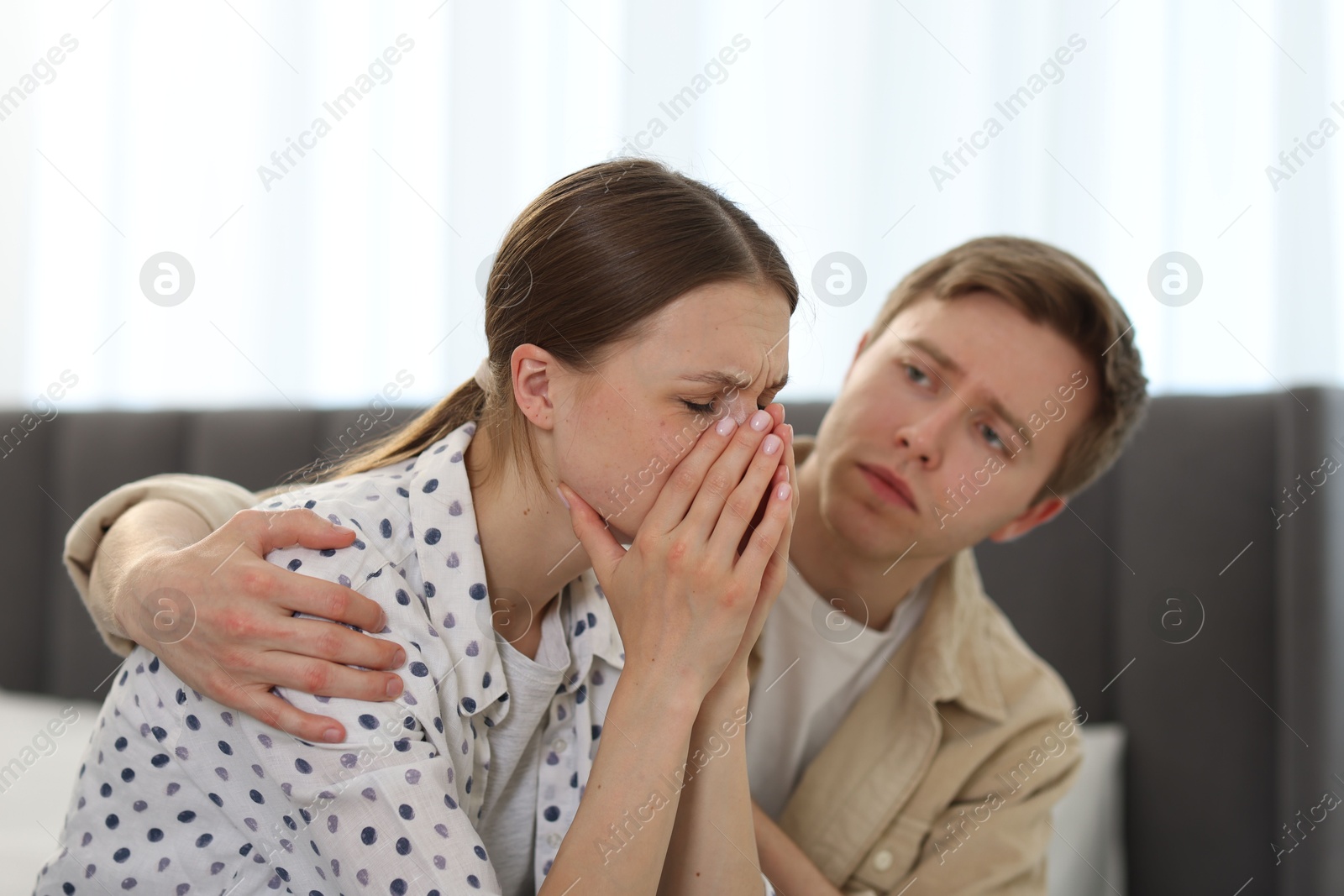 Man apologizing to his crying girlfriend at home Photo of Man apologizing to his crying girlfriend at home