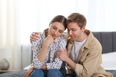 Photo of Lovely couple after apology on bed at home