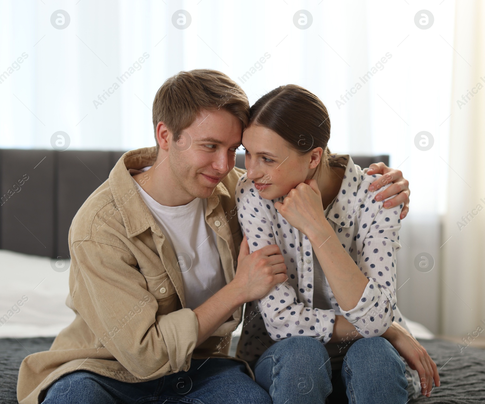Photo of Lovely couple after apology on bed at home
