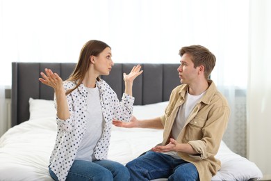 Photo of Man apologizing to his wife while she resenting on bed at home