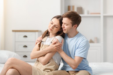 Photo of Happy couple after apology on bed at home