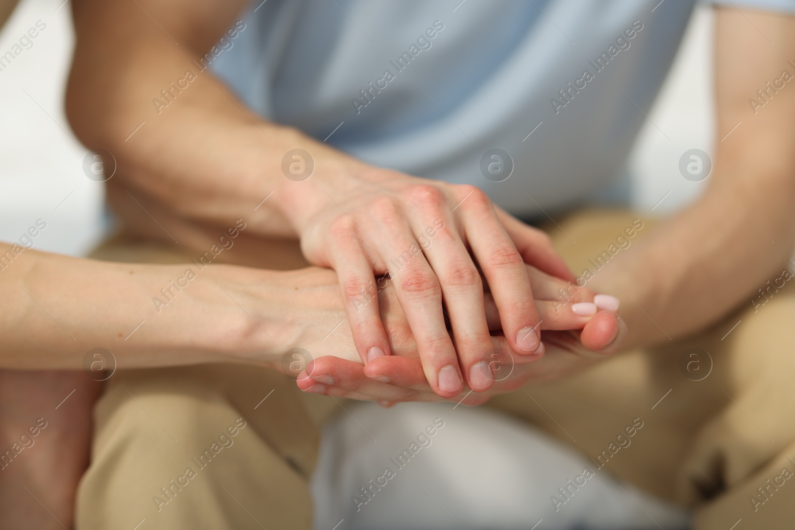 Couple holding hands after apology indoors, closeup Photo of Couple holding hands after apology indoors, closeup