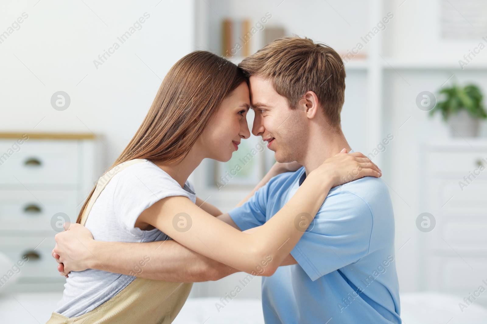 Photo of Happy couple hugging after apology at home