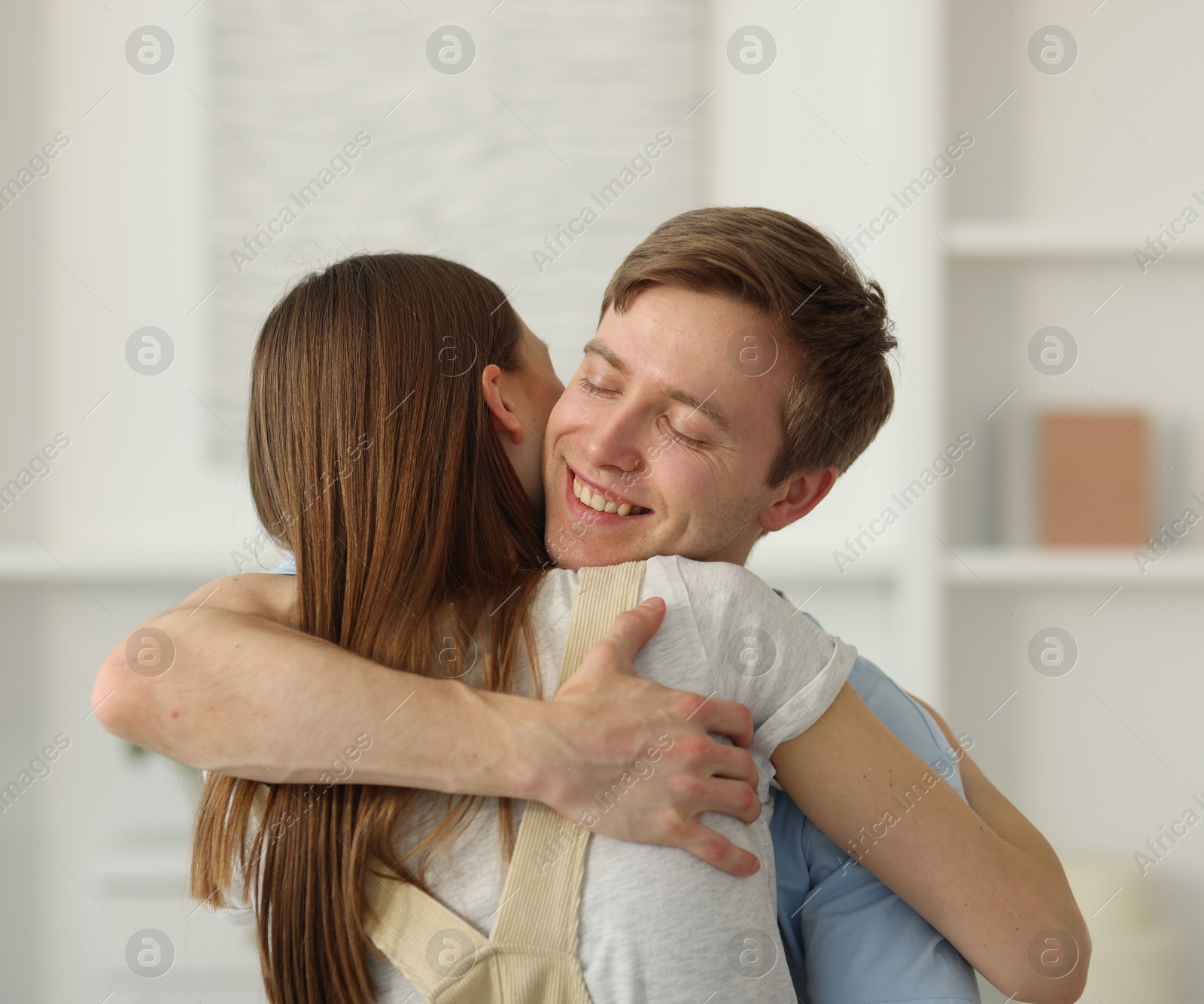 Photo of Happy couple hugging after apology at home