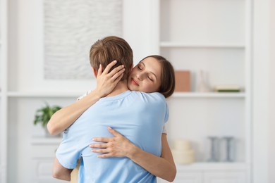 Photo of Lovely couple hugging after apology at home