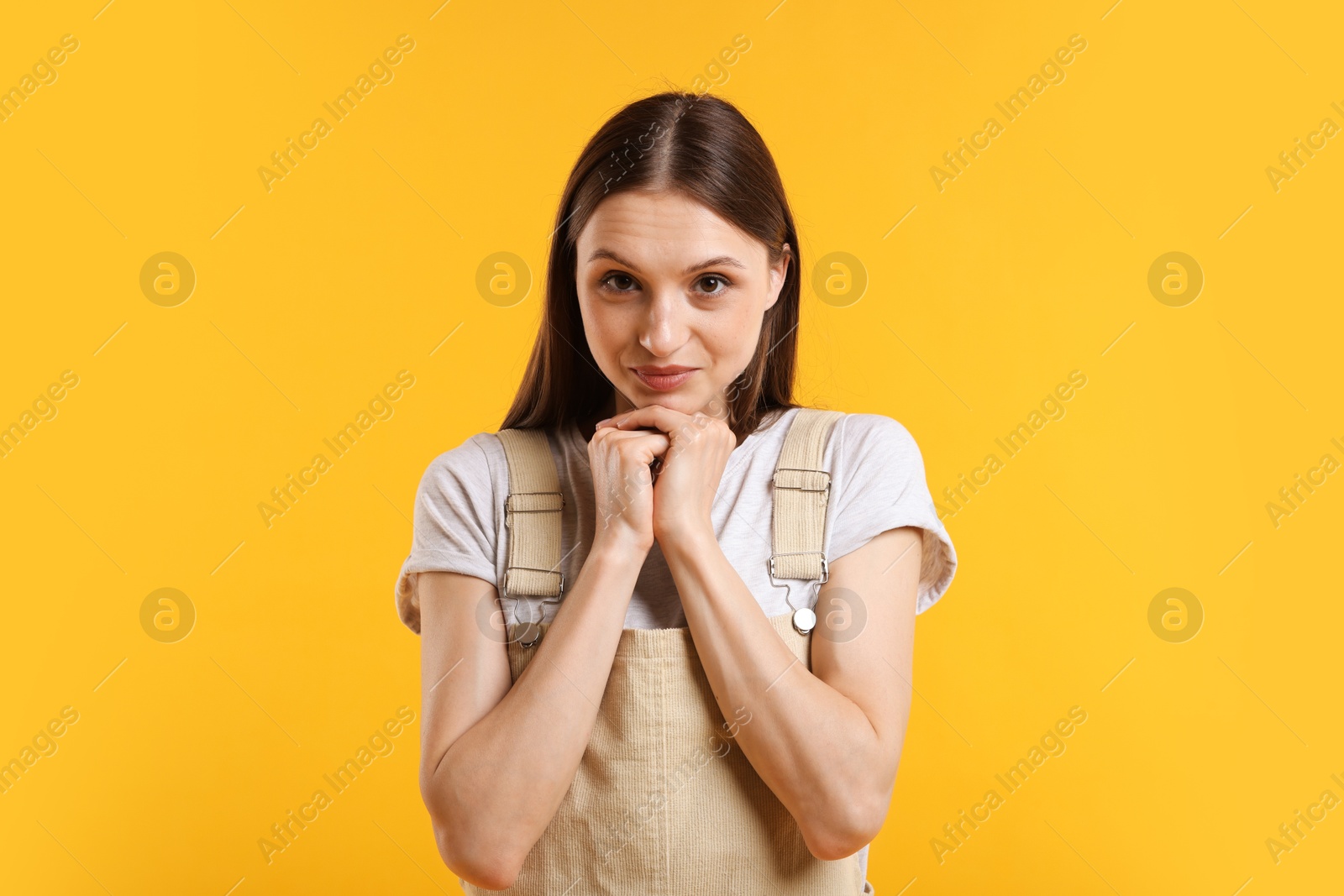 Photo of Portrait of confused woman apologizing on yellow background