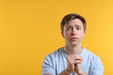 Photo of Man apologizing on yellow background. Space for text