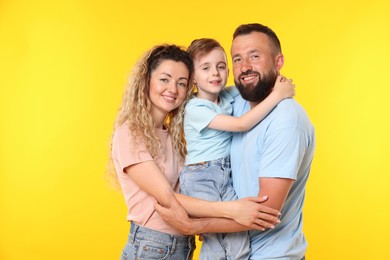 Photo of Portrait of happy family on yellow background