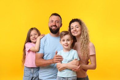 Photo of Portrait of happy family on yellow background