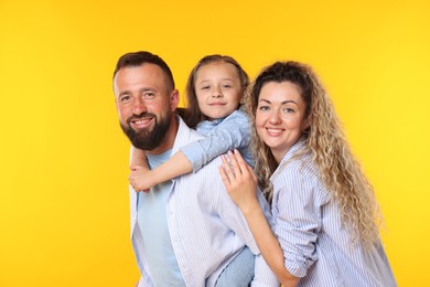 Photo of Portrait of happy family on yellow background
