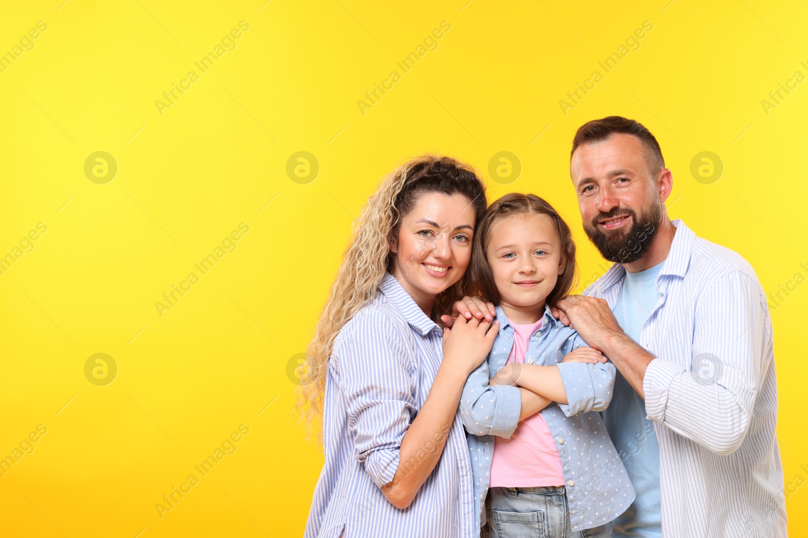 Portrait of happy family on yellow background. Space for text Photo of Portrait of happy family on yellow background. Space for text