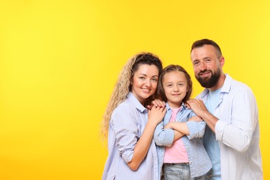 Photo of Portrait of happy family on yellow background. Space for text