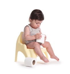Photo of Cute little baby sitting on potty with toilet paper against white background