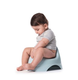 Photo of Cute little baby sitting on potty against white background