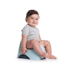 Photo of Cute little baby sitting on potty against white background