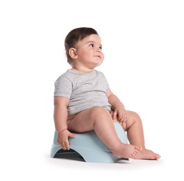 Photo of Cute little baby sitting on potty against white background