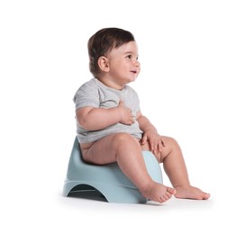 Photo of Cute little baby sitting on potty against white background
