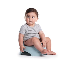 Photo of Cute little baby sitting on potty against white background