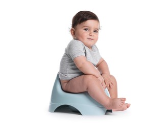 Photo of Cute little baby sitting on potty against white background