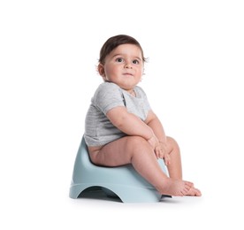 Photo of Cute little baby sitting on potty against white background