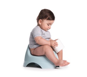 Photo of Cute little baby sitting on potty with toilet paper against white background