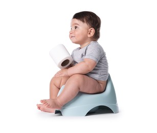 Photo of Cute little baby sitting on potty with toilet paper against white background