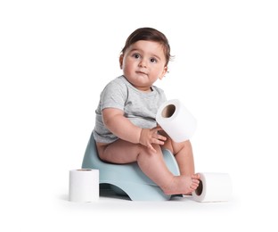 Photo of Cute little baby sitting on potty with toilet paper against white background