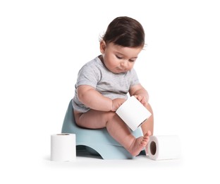 Photo of Cute little baby sitting on potty with toilet paper against white background