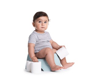Photo of Cute little baby sitting on potty with toilet paper against white background