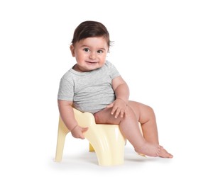 Photo of Cute little baby sitting on potty against white background