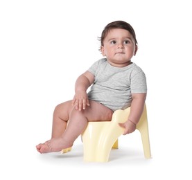 Photo of Cute little baby sitting on potty against white background