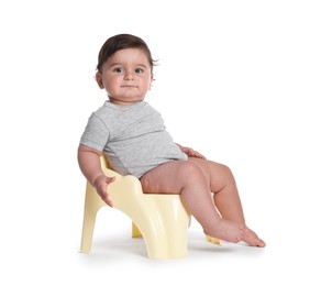 Photo of Cute little baby sitting on potty against white background