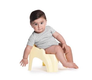 Photo of Cute little baby sitting on potty against white background