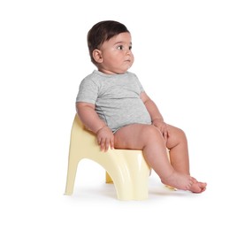Photo of Cute little baby sitting on potty against white background