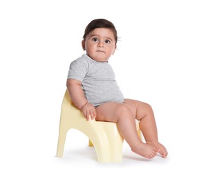 Photo of Cute little baby sitting on potty against white background