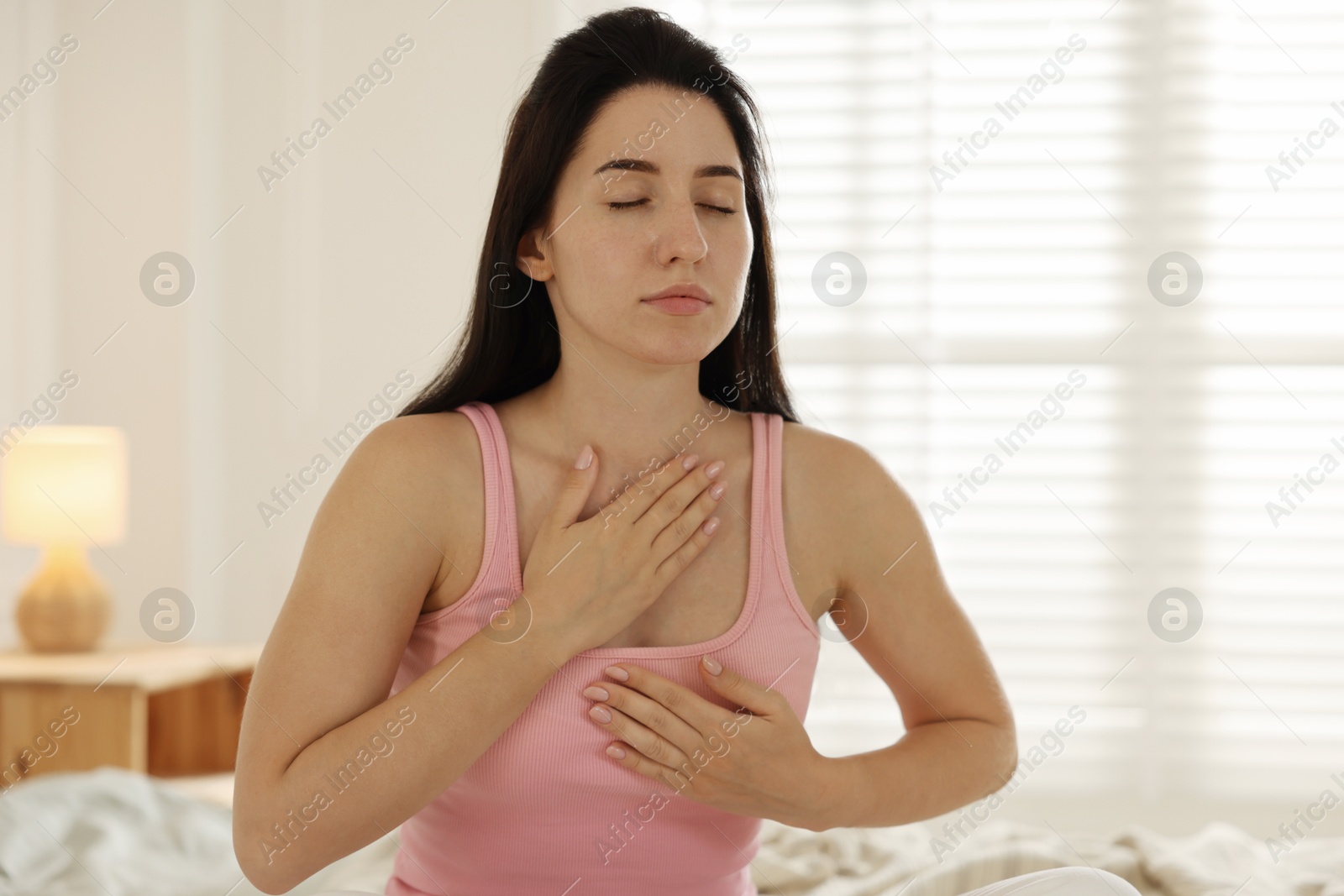 Panic attack. Woman breathing to calm down at home Photo of Panic attack. Woman breathing to calm down at home