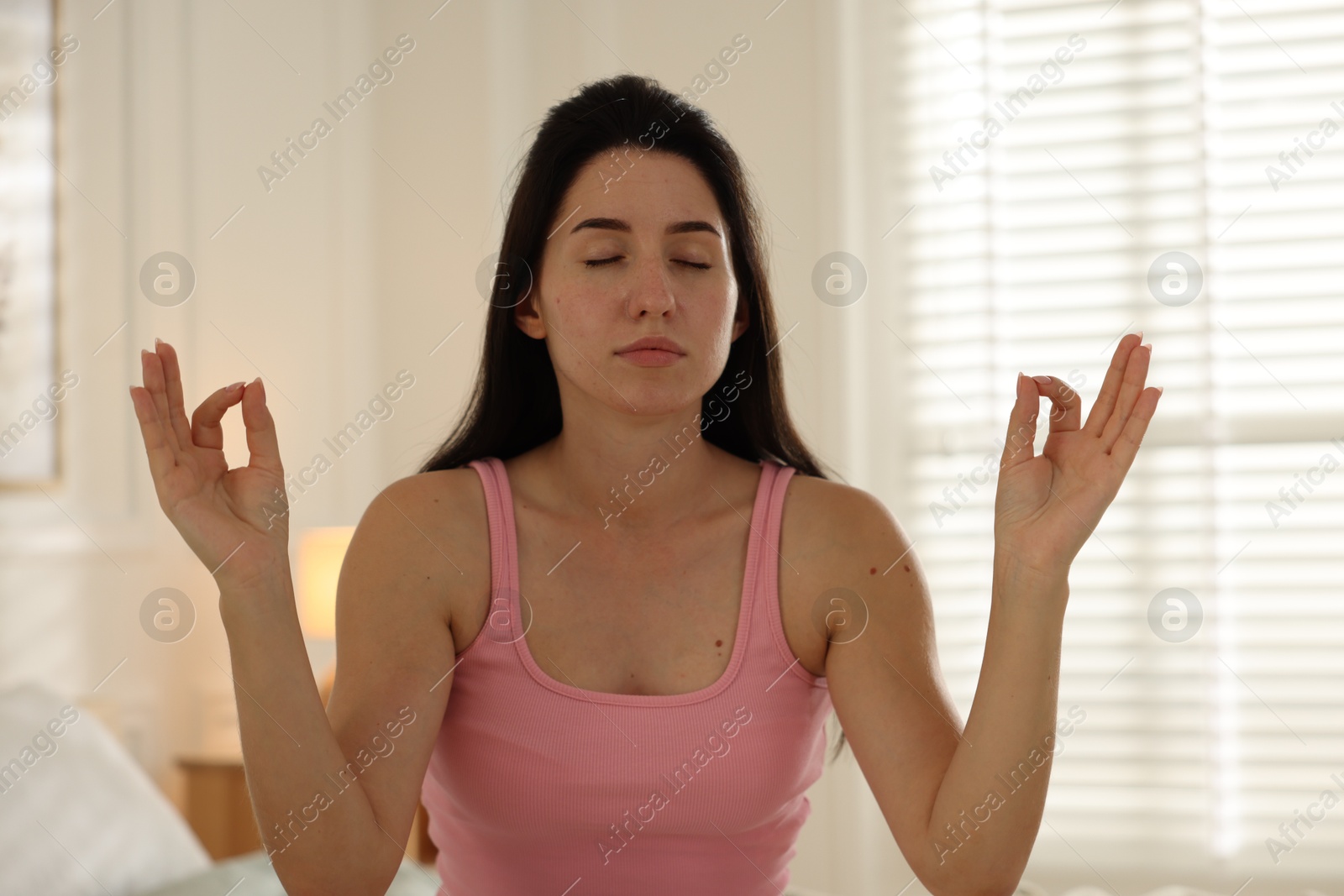 Panic attack. Woman meditating to calm down at home Photo of Panic attack. Woman meditating to calm down at home