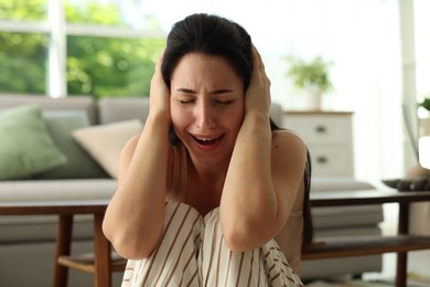 Photo of Woman suffering from panic attack at home