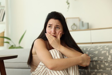 Photo of Woman suffering from panic attack at home