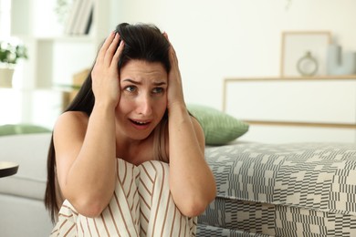 Photo of Woman suffering from panic attack at home