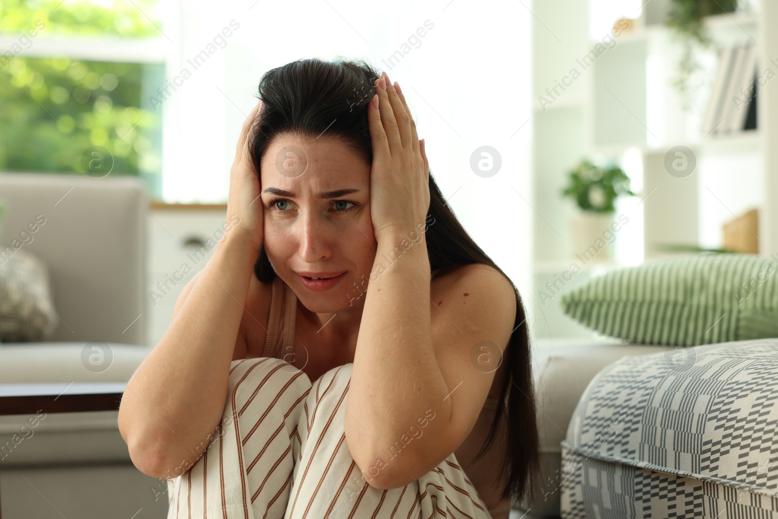 Woman suffering from panic attack at home Photo of Woman suffering from panic attack at home